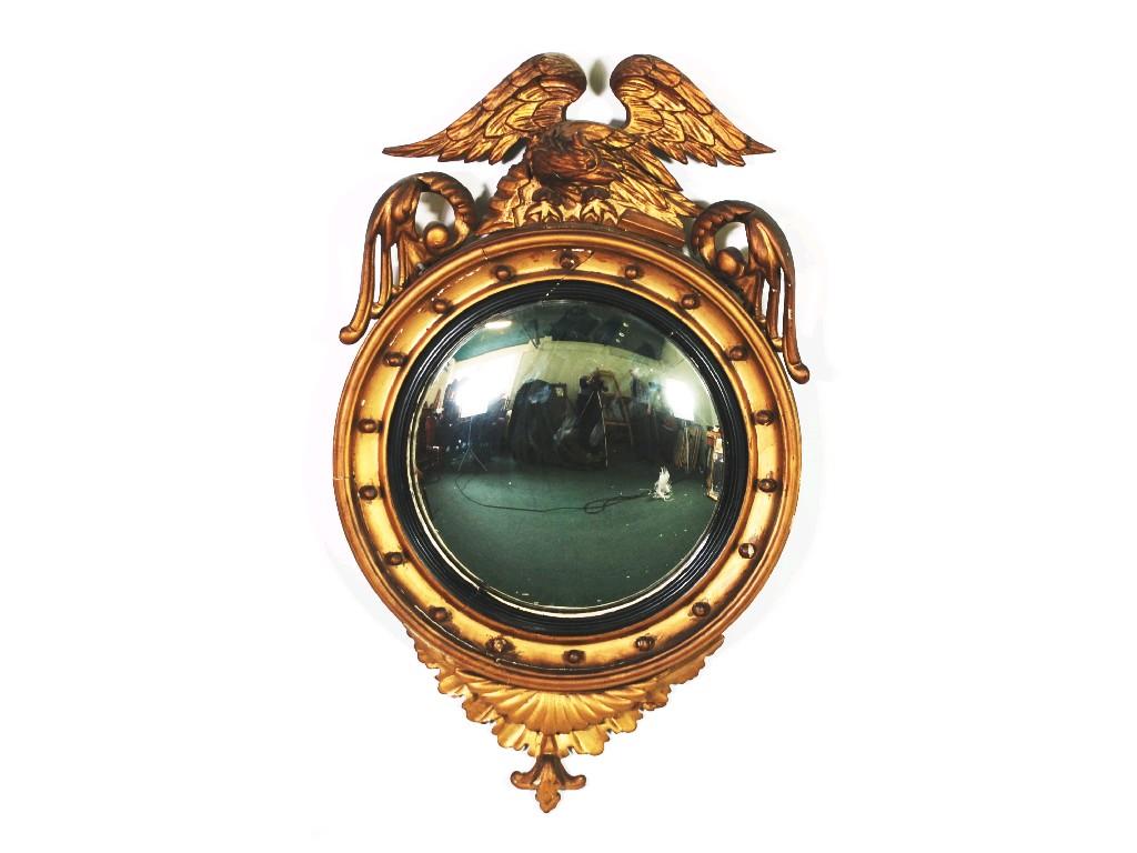 Appraisal: REGENCY CARVED GILTWOOD FRAMED CONVEX WALL MIRROR with displayed eagle