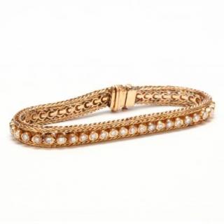 Appraisal: KT Gold and Diamond Bracelet the flexible bracelet centered with