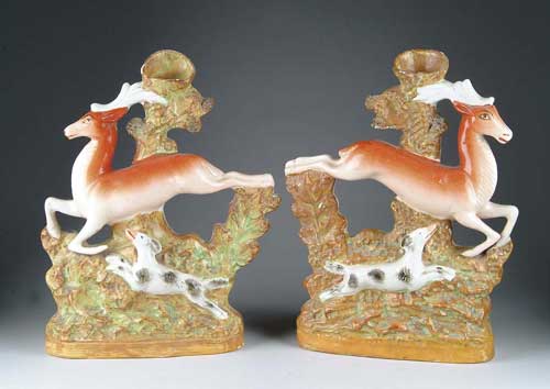 Appraisal: PAIR OF STAFFORDSHIRE DEER SPILL VASES Opposing figures of running