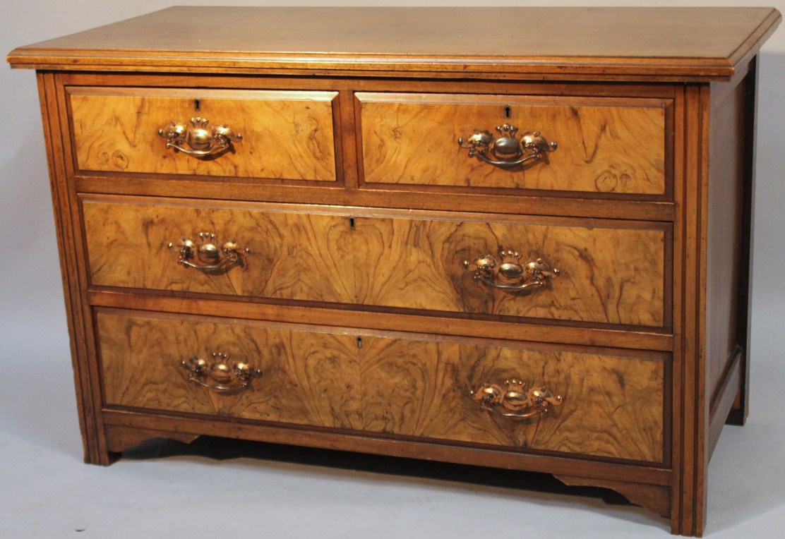 Appraisal: An Edwardian walnut veneered low chest of two short and