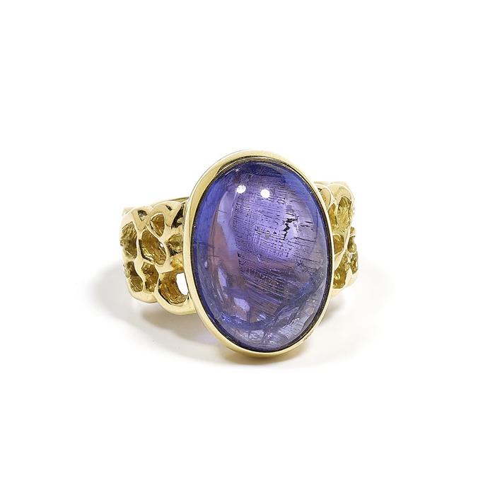 Appraisal: TANZANITE AND GOLD RING Yellow gold Casual-decorative open-worked band ring