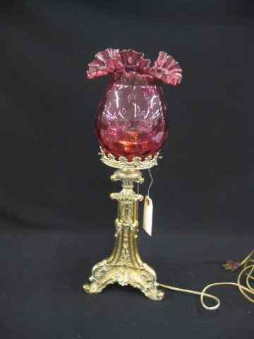 Appraisal: Victorian Lamp ornate brass base with cranberry art glass shade