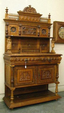 Appraisal: Antique English chestnut carved sideboard two-piece with figural carvings on