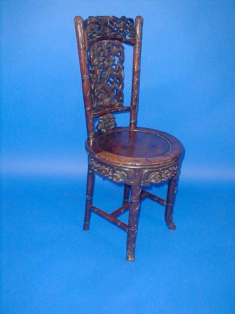 Appraisal: A Chinese rosewood chair with bamboo carved and pierced splat