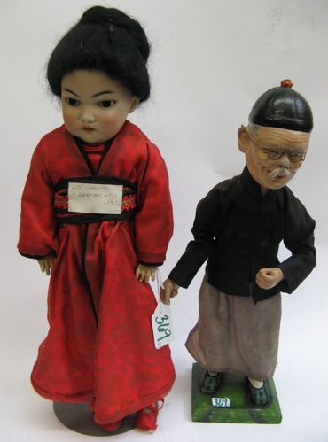 Appraisal: TWO ASIAN DOLLS One a bisque head girl doll black