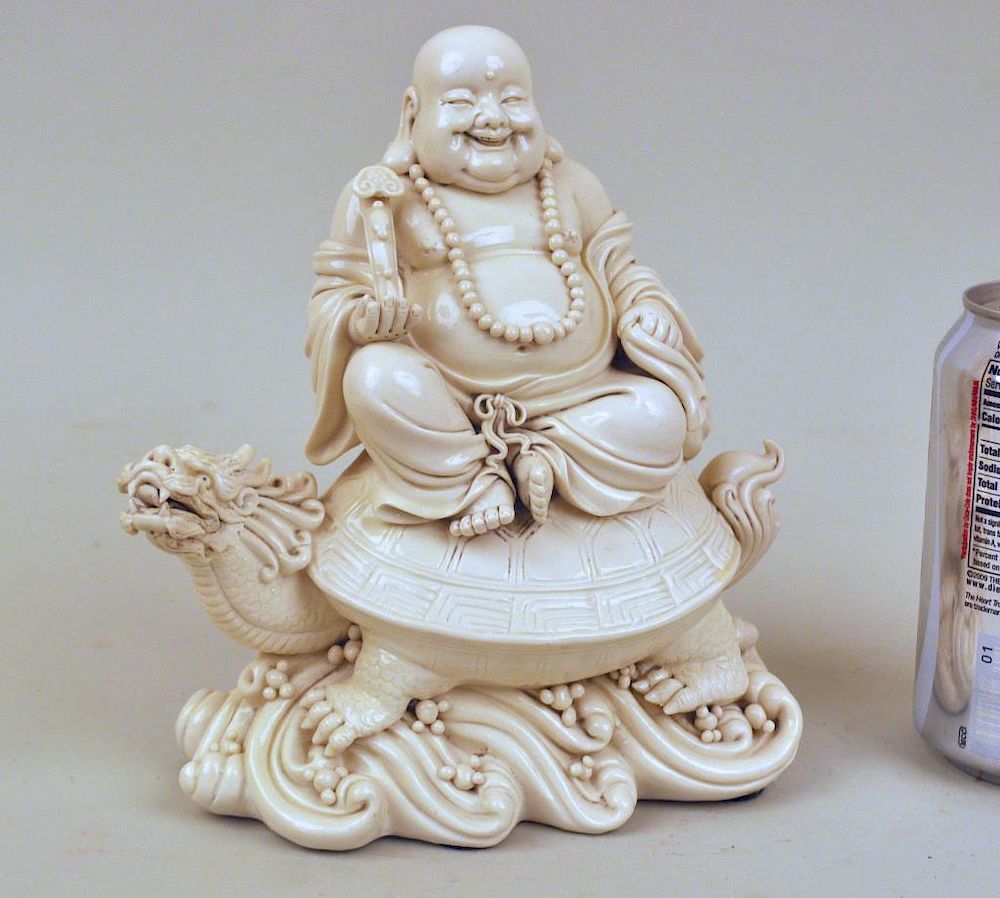 Appraisal: Chinese Blanc De Chine Hotei Figure astride mythical turtle high