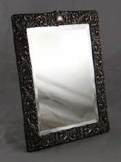 Appraisal: A sterling silver faced mirror with strut back and bevelled