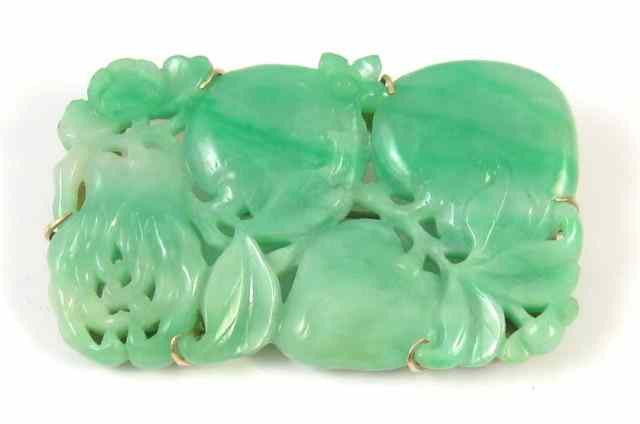 Appraisal: LARGE CARVED GREEN JADE BROOCH The pierced-carved jade brooch is