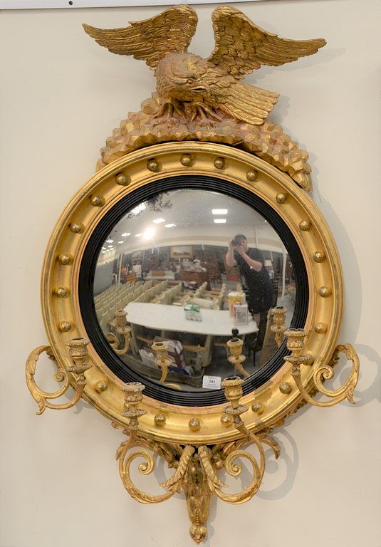 Appraisal: Girandole convex mirror mounted with carved eagle and four candle