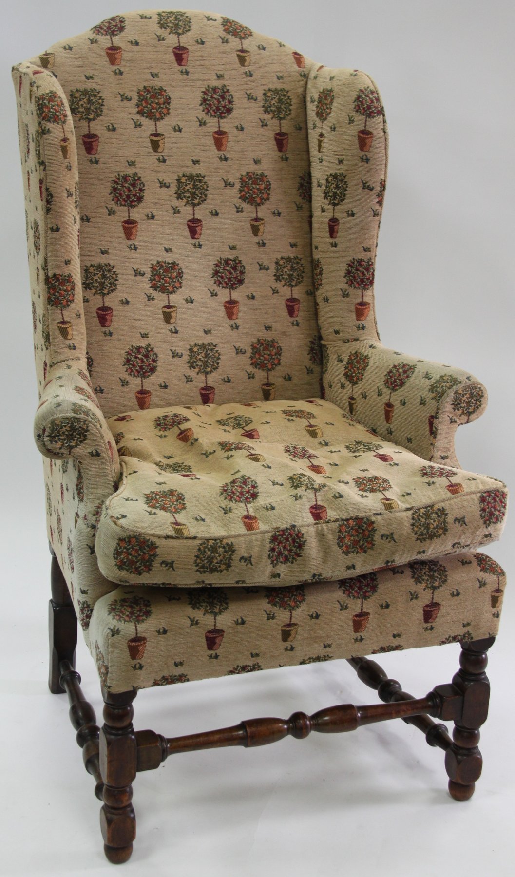 Appraisal: An oak framed wing armchair on turned supports with turned