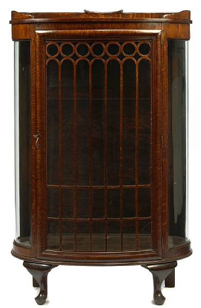 Appraisal: An American oak curio cabinet with curved glass height in