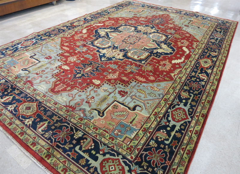 Appraisal: HAND KNOTTED ORIENTAL CARPET Persian Serapi design the brick-red ground