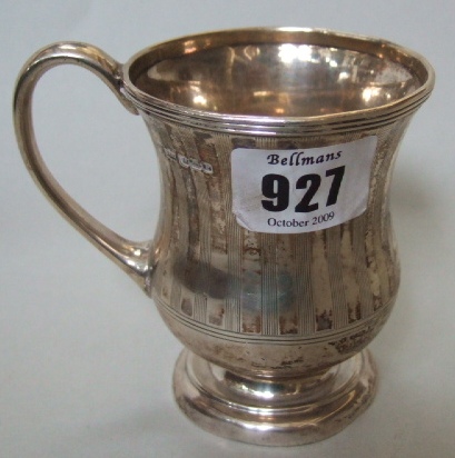 Appraisal: A silver christening mug of wasted form with banded decoration