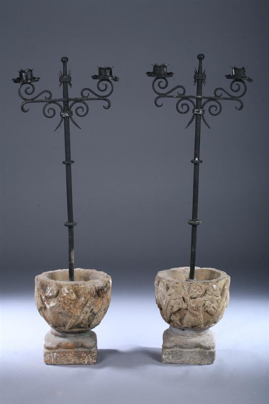 Appraisal: PAIR ASSEMBLED CAST STONE AND WROUGHT-IRON TWO-LIGHT CANDELABRA th century