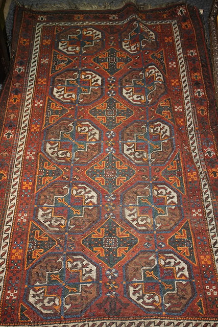 Appraisal: A HAMADAN RED GROUND RUG with medallions within a multiple