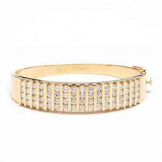 Appraisal: KT Gold and Diamond Bracelet of hinged and tapered bangle