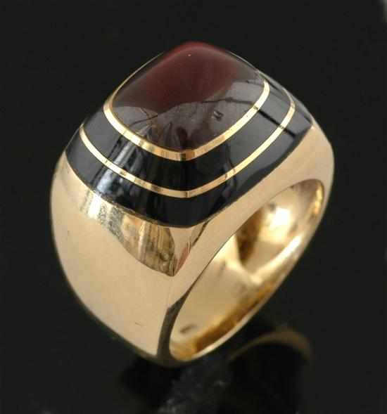 Appraisal: A garnet and onyx dress ring Of contemporary design centrally