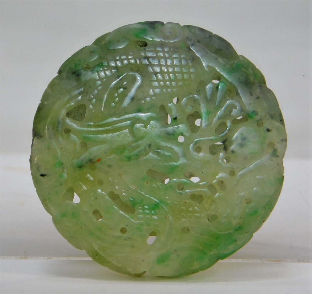 Appraisal: CHINESE CELADON JADE RETICULATED DRAGON MEDALLION China Qing DynastyIncised and