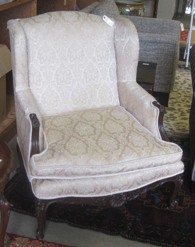 Appraisal: LOUIS XV STYLE WINGBACK ARMCHAIR having a carved and molded