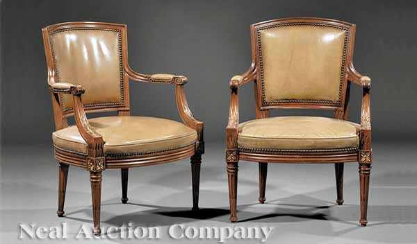 Appraisal: A Pair Louis XVI-Style Carved Walnut Fauteuils molded backs scroll