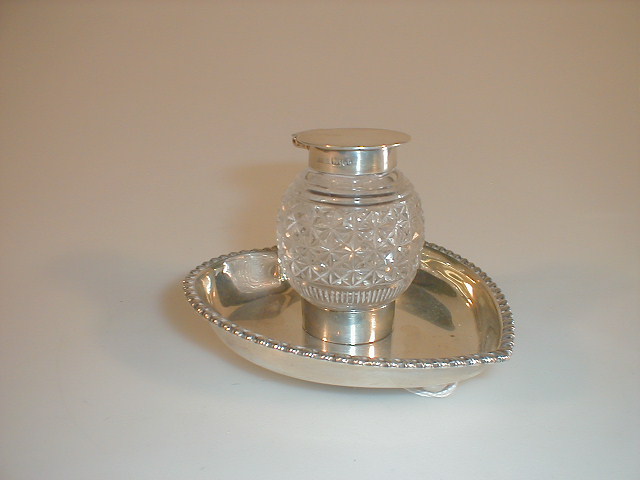 Appraisal: An Edwardian silver ink stand with cut crystal silver top