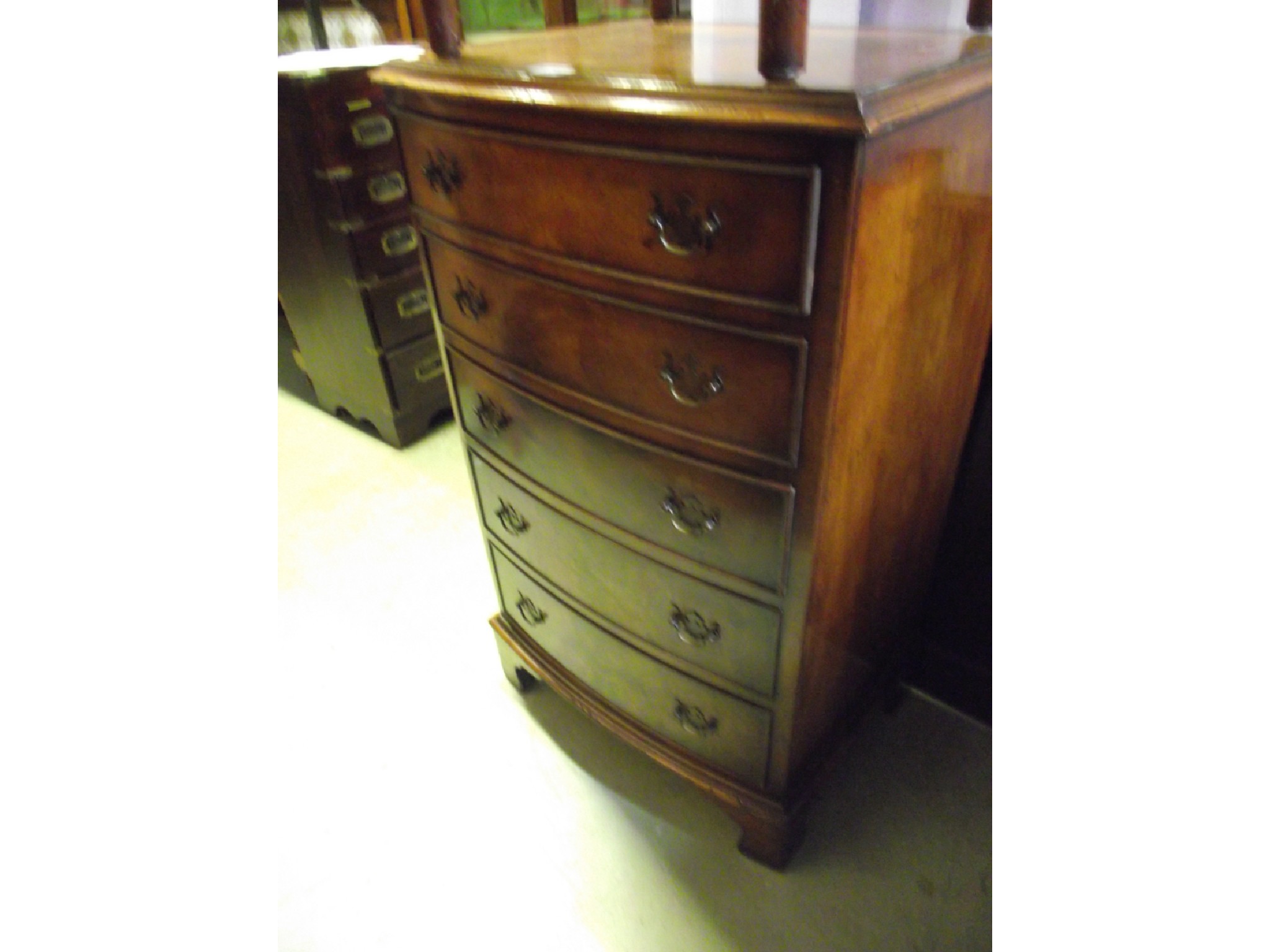 Appraisal: A small walnut veneered and bow fronted bedroom chest in