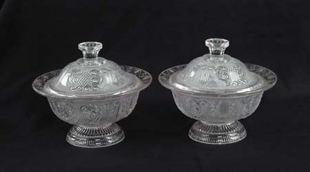 Appraisal: PAIR OF PRESSED CLEAR SANDWICH SWEET MEAT COVERED DISHES Footed