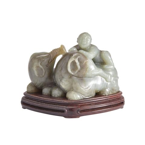 Appraisal: A Jade Carving of Boy and Elephants with a Zitan