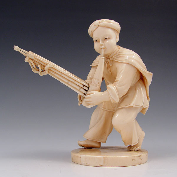 Appraisal: CARVED IVORY FIGURE OF A MUSICIAN WITH PIPES Signed ''