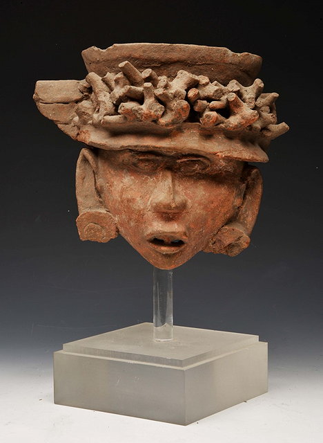 Appraisal: A SOUTH AMERICAN POTTERY MASK with crown of thorns wreath