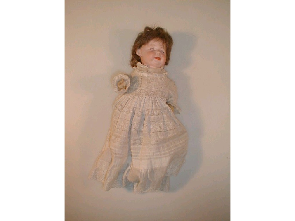 Appraisal: A German bisque headed doll with brown wig sleeping eyes