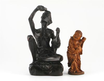 Appraisal: A Chinese hardwood carving of a figure holding a string