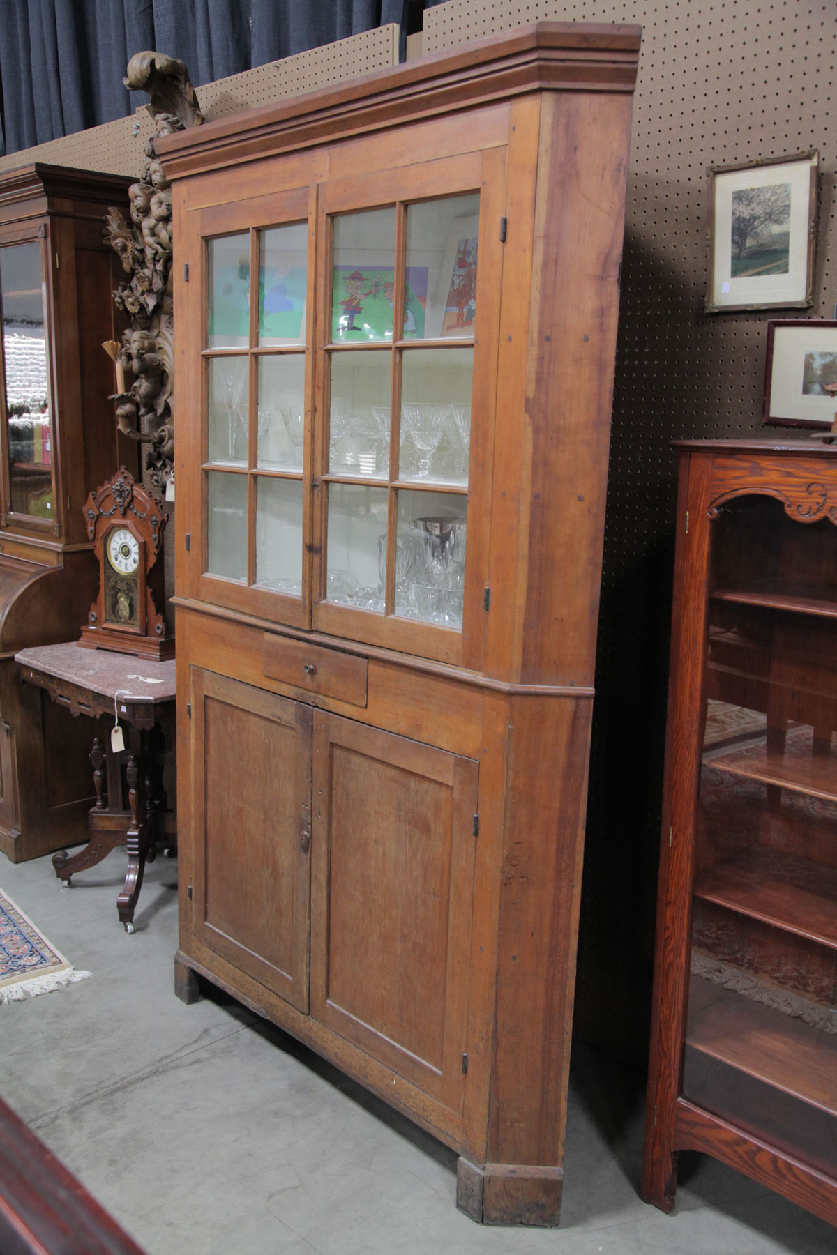 Appraisal: ONE PIECE CORNER CUPBOARD American th century Cherry with old