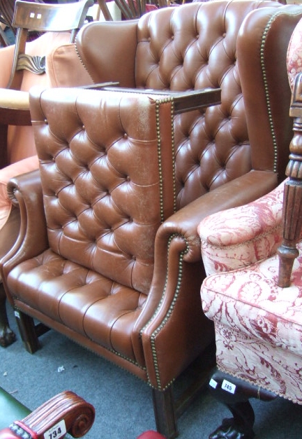 Appraisal: A mid th century style wing back armchair with studded