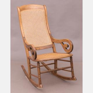 Appraisal: An American Walnut Rocking Chair with Caned Seat and Back