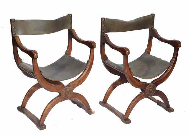 Appraisal: A PAIR OF CONTINENTAL WALNUT 'X' FRAMED OPEN ARMCHAIRS with