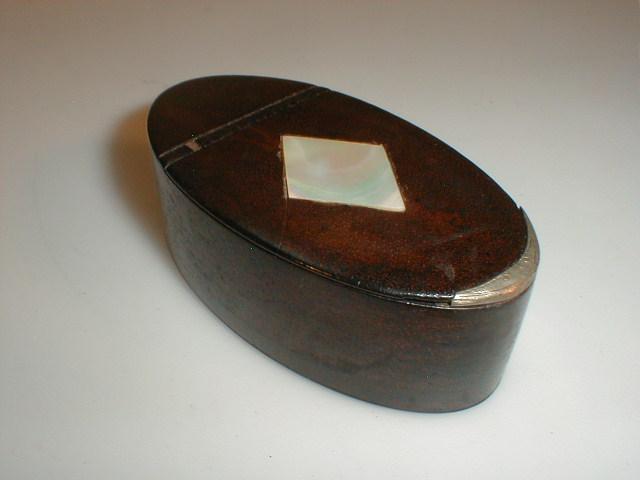 Appraisal: A Georgian oval leather snuff box the hinged lid set