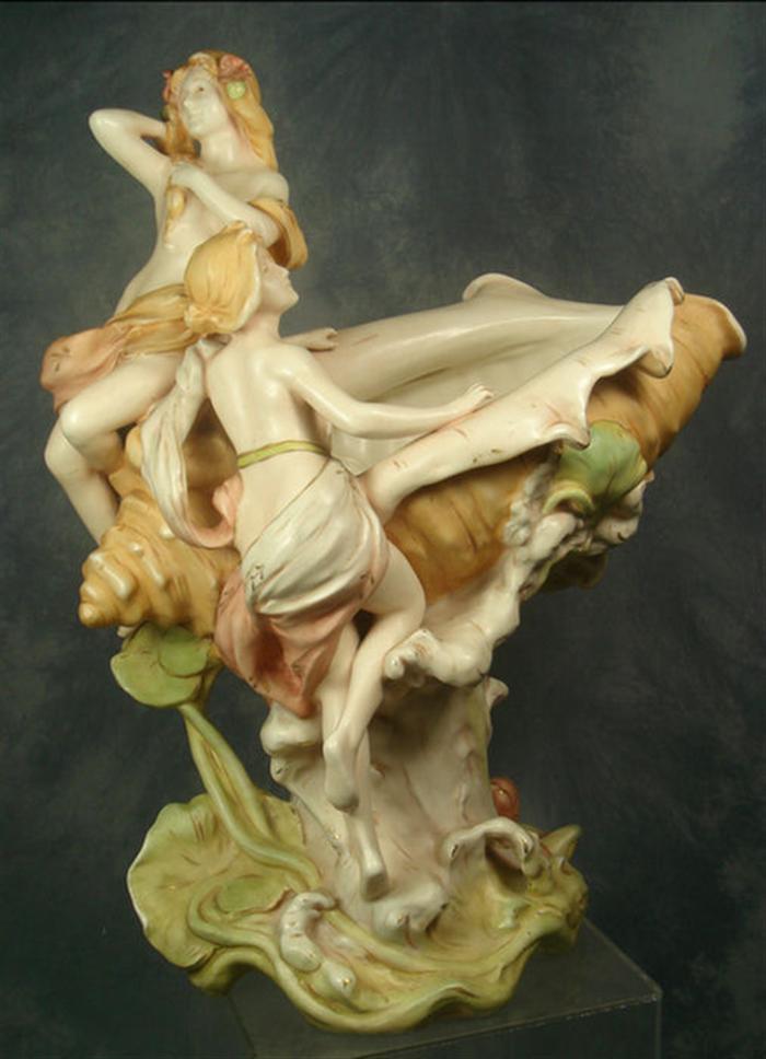 Appraisal: Art nouveau porcelain grouping nudes astride a conch shell base