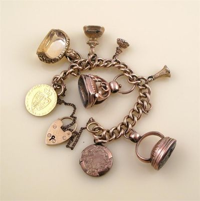 Appraisal: A gold charm bracelet The ct gold curb link bracelet