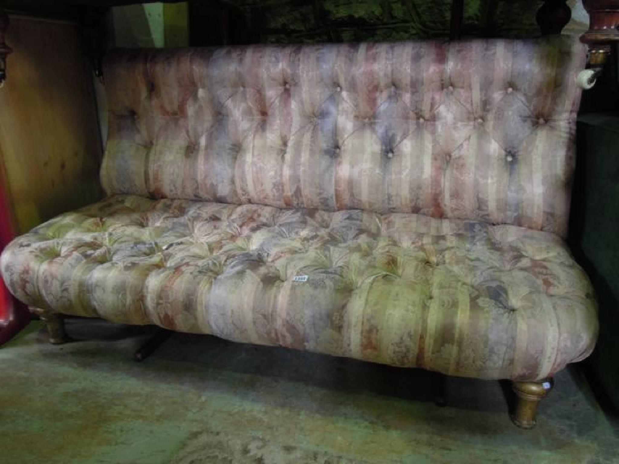 Appraisal: A Victorian couch with buttoned floral upholstered seat and back