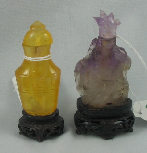 Appraisal: TWO CARVED CHINESE SNUFF BOTTLES One is an Amethyst quartz