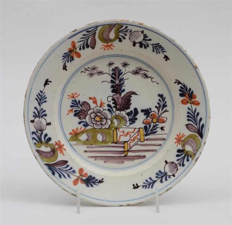 Appraisal: DUTCH DELFT POLYCHROME PLATE Circa showing a garden view with