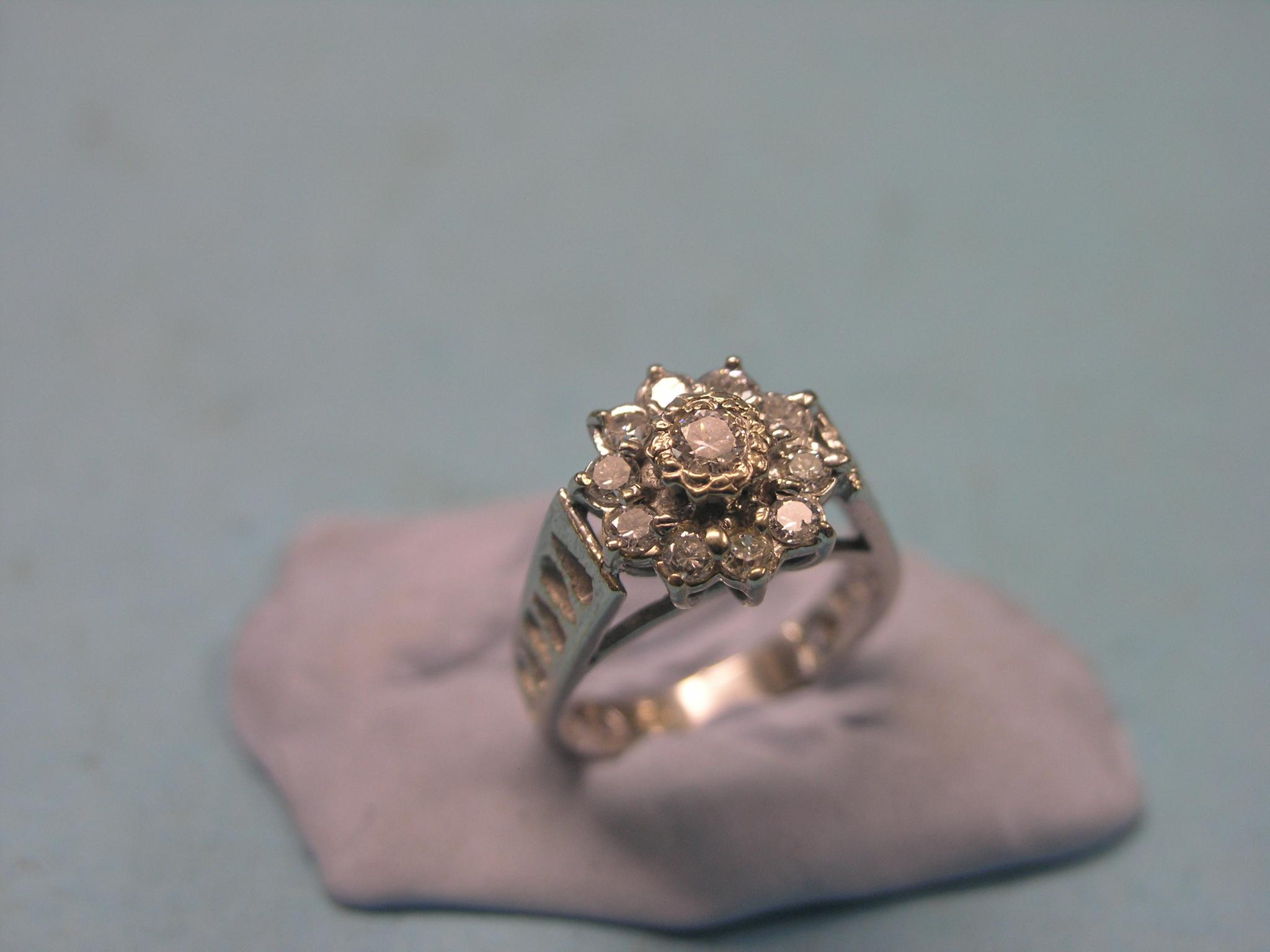 Appraisal: A diamond cluster ring rosette design of eleven stones pierced