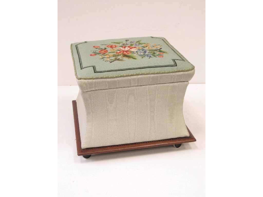 Appraisal: An upholstered Ottoman with floral tapestry top and mahogany base