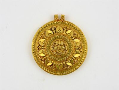 Appraisal: An Indian gold foil covered hair ornament formed as a