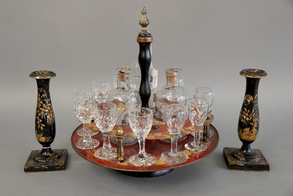 Appraisal: A regency gilt and red lacquered drinks stand holding glasses