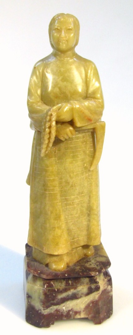 Appraisal: An early thC Chinese soapstone figure in flowing robes holding