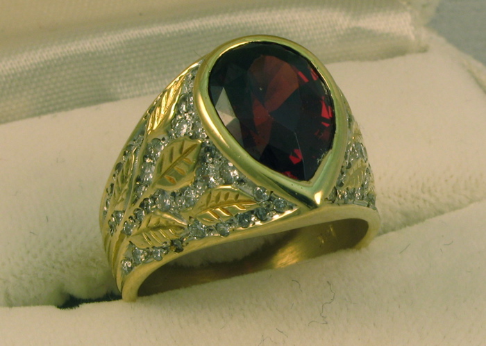 Appraisal: MAN'S GARNET DIAMOND AND EIGHTEEN KARAT GOLD RING set with