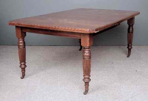 Appraisal: A late Victorian walnut extending dining table with one extra