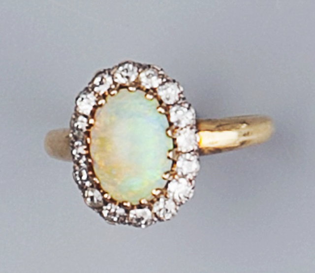 Appraisal: AN OPAL AND DIAMOND OVAL CLUSTER RING the oval cabochon